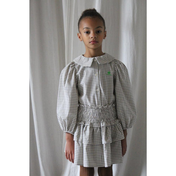 Wit Leonie rokje met zwart vierkantenpatroon van We Are Kids. | Verkrijgbaar bij Little Fashion Addict