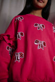 Donkerroze meisjessweater met glinsterende strikjes van Daily Brat – City Notes Collectie | Ontdek Daily Brat bij Little Fashion Addict