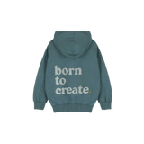 Detail van de Born to Create-print op de petrolgroene Jenest hoodie | Verkrijgbaar bij Little Fashion Addict