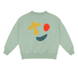 Happy Bird Sweater Sage Green van Jenest – saliegroene unisex sweater met grafische rugprint in biologisch katoen | Ontdek Jenest bij Little Fashion Addict