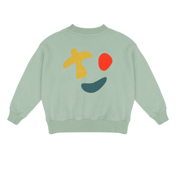 Happy Bird Sweater Sage Green van Jenest – saliegroene unisex sweater met grafische rugprint in biologisch katoen | Ontdek Jenest bij Little Fashion Addict