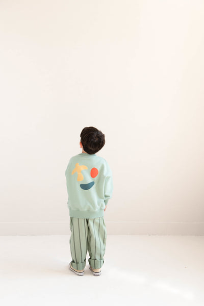 Happy Bird Sweater Sage Green van Jenest – saliegroene unisex sweater met grafische rugprint in biologisch katoen | Ontdek Jenest bij Little Fashion Addict