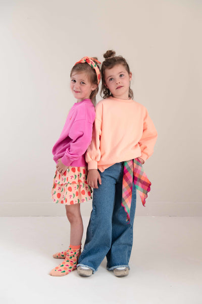 Pippa Sweater Peach Orange van Jenest – abrikooskleurige oversized meisjes sweater met bloemenprint op de rug | Ontdek Jenest bij Little Fashion Addict