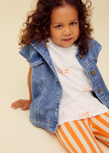 Meisje draagt off-white unisex t-shirt met ijsjesprint van Sproet & Sprout, comfortabele zomerlook voor warme dagen. | Verkrijgbaar bij Little Fashion Addict