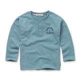 Littlefashionaddict - Sproet & Sprout - AW23 - The Alpine Hut - Grandad Sweatshirt Raclette Vedette - In het lichtblauw en met lange mouwen - Jongensmode - Vanaf 4 tot 10 jaar in stock en verkrijgbaar bij Little Fashion Addict