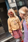 Rok met paarse en rode strepen uit de A Cosmic Romance collectie van Sproet & Sprout. | Smock Skirt Stripe Lavender
