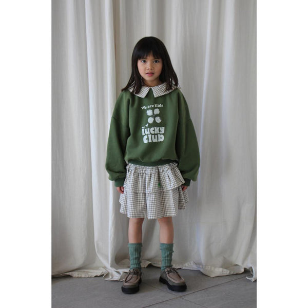 Wit Leonie rokje met zwart vierkantenpatroon van We Are Kids. | Verkrijgbaar bij Little Fashion Addict